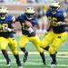 Michigan junior quarterback Denard Robinson runs behind sophomore running back Fitzgerald Toussaint and senior tight end Kevin Koger during the first half against Eastern Michigan at Michigan Stadium on Saturday. Melanie Maxwell I AnnArbor.com